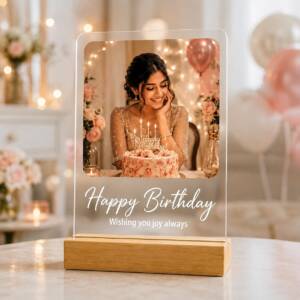 Birthday acrylic photo frame with example photograph and wording on its pinewood stand